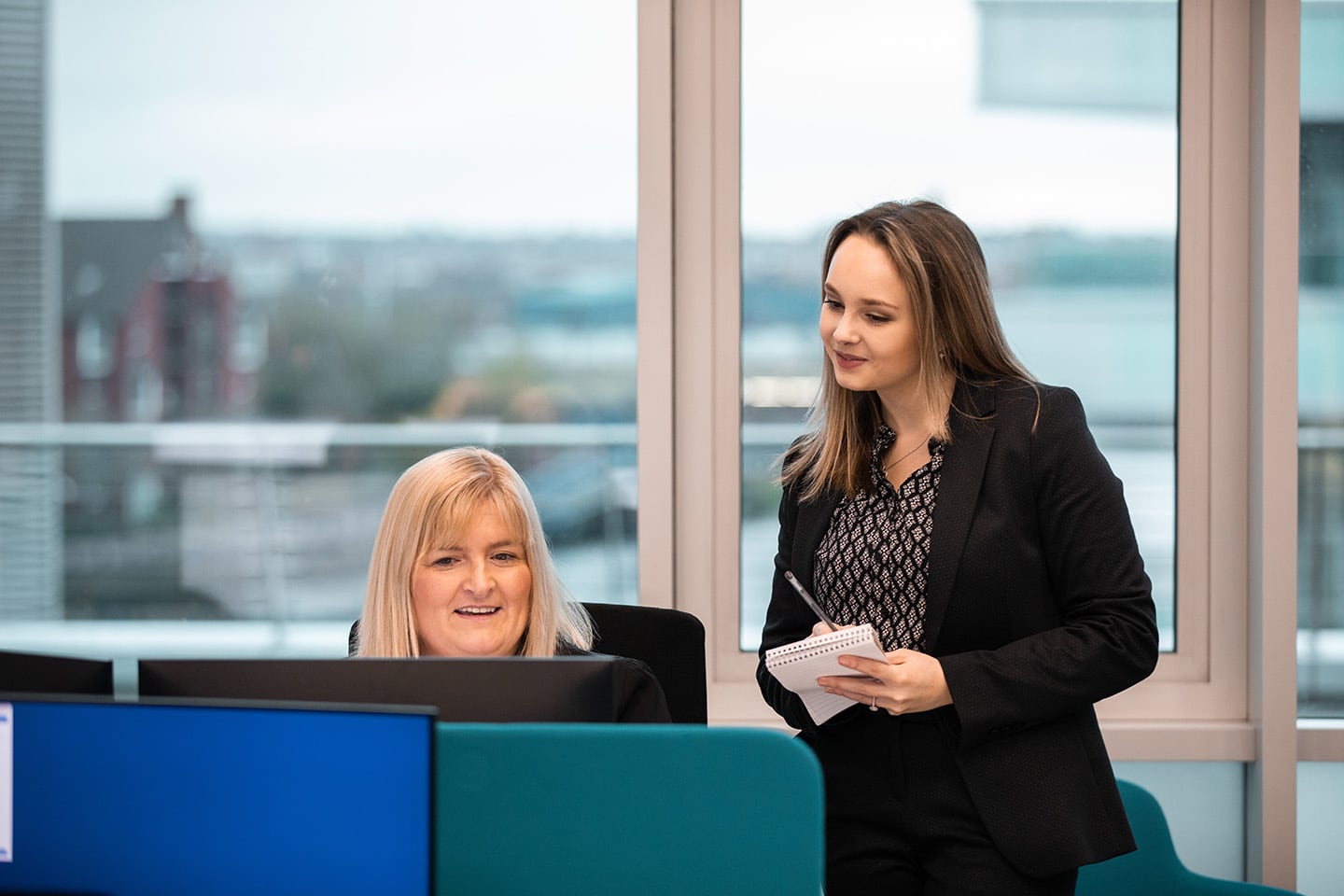 A secretary and trainee solicitor taking notes at Paschal O’Hare Personal Injury Solicitors’ Belfast office.