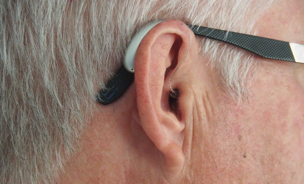 installing a hearing aid in order to claim hearing loss compensation